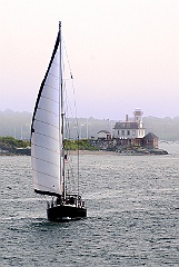 Saliboat Passes By Rose Island Lighthouse in the Fog